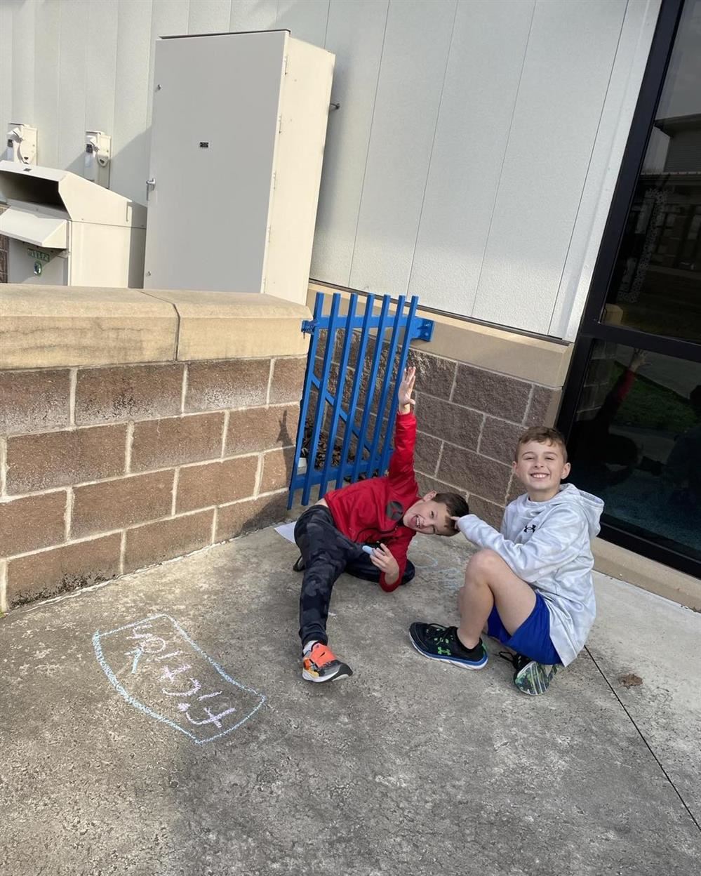  students enjoying the nice weather while working on phonics